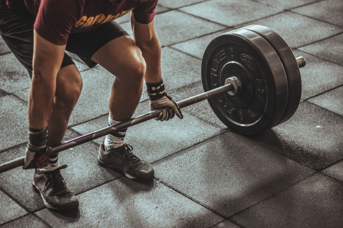 gym floor with weights and barbell